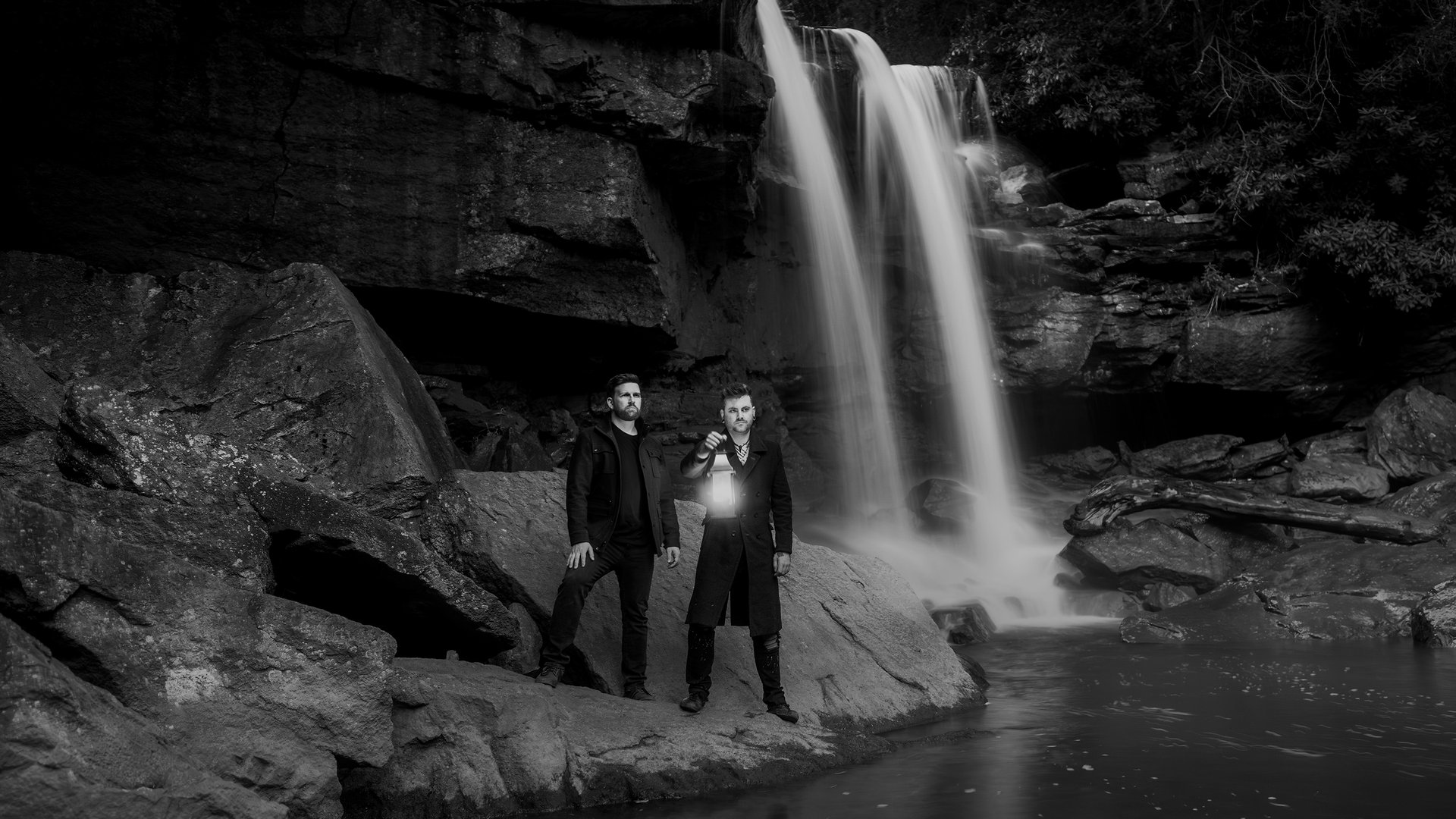Tuomas Kasselgaard Easton and Steve Rowley standing beside a waterfall.